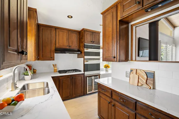 a kitchen with a sink and a stove top oven