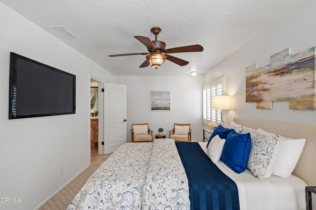 3715 Sunset Lane Oxnard, CA 93035 - Photo 20 of 45 a bedroom with a bed and a chandelier