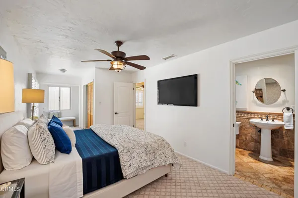 a bedroom with a bed and a flat screen tv