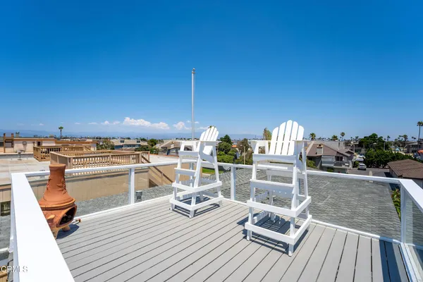 a view of a balcony with wooden floor and seating space