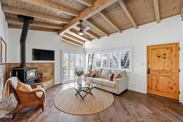 a living room with fireplace furniture and a flat screen tv