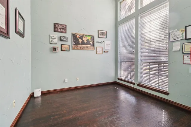 a view of a room with wooden floor and window