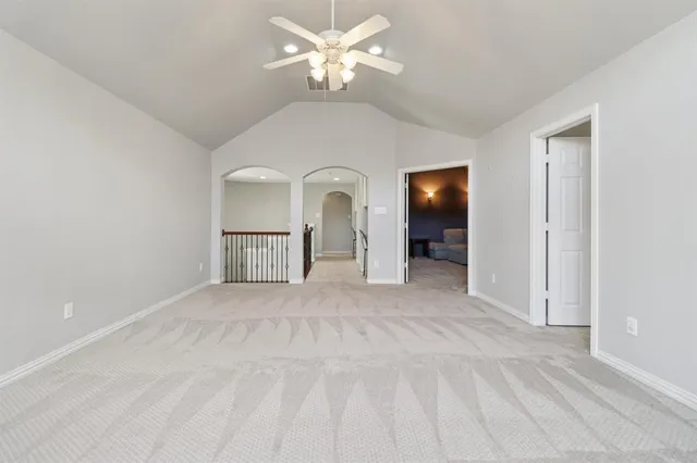 a view of a big room with closet and a chandelier fan