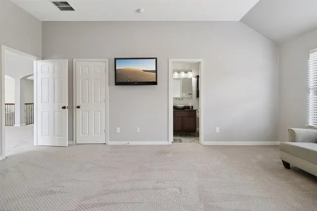a view of a livingroom with furniture and a hallway