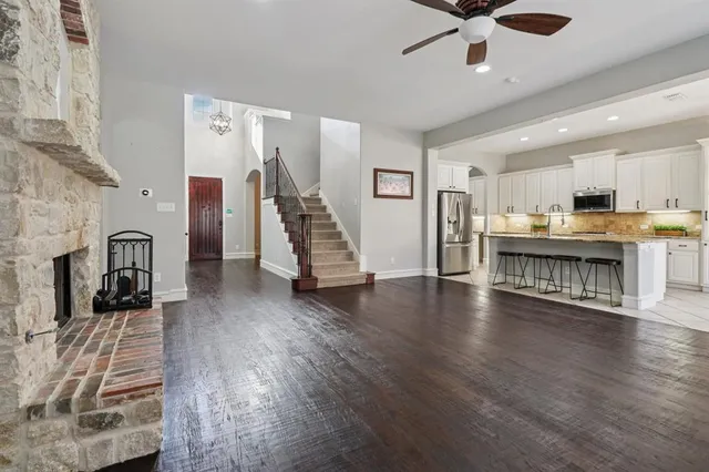 a view of a living room a kitchen and a wooden floor