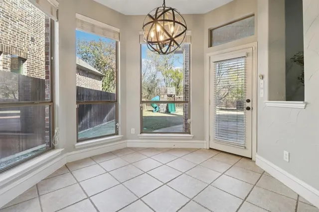 a view of an entryway with wooden floor and door