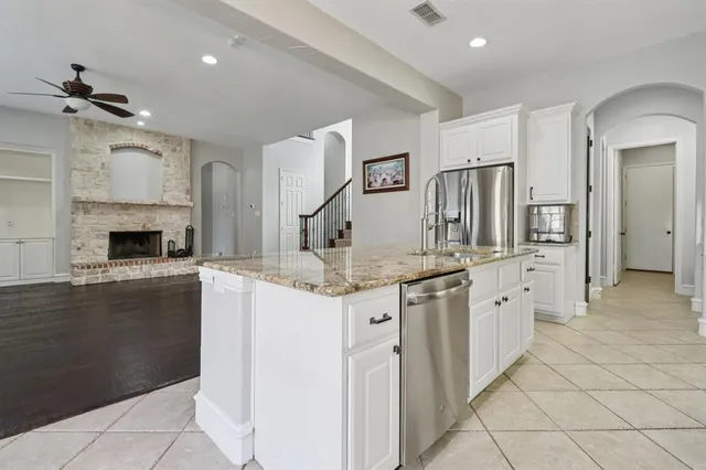 a kitchen with granite countertop a sink and cabinets