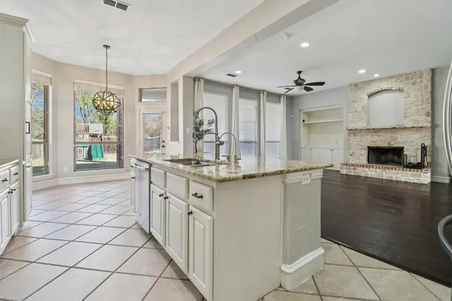 a kitchen with granite countertop a sink and cabinets