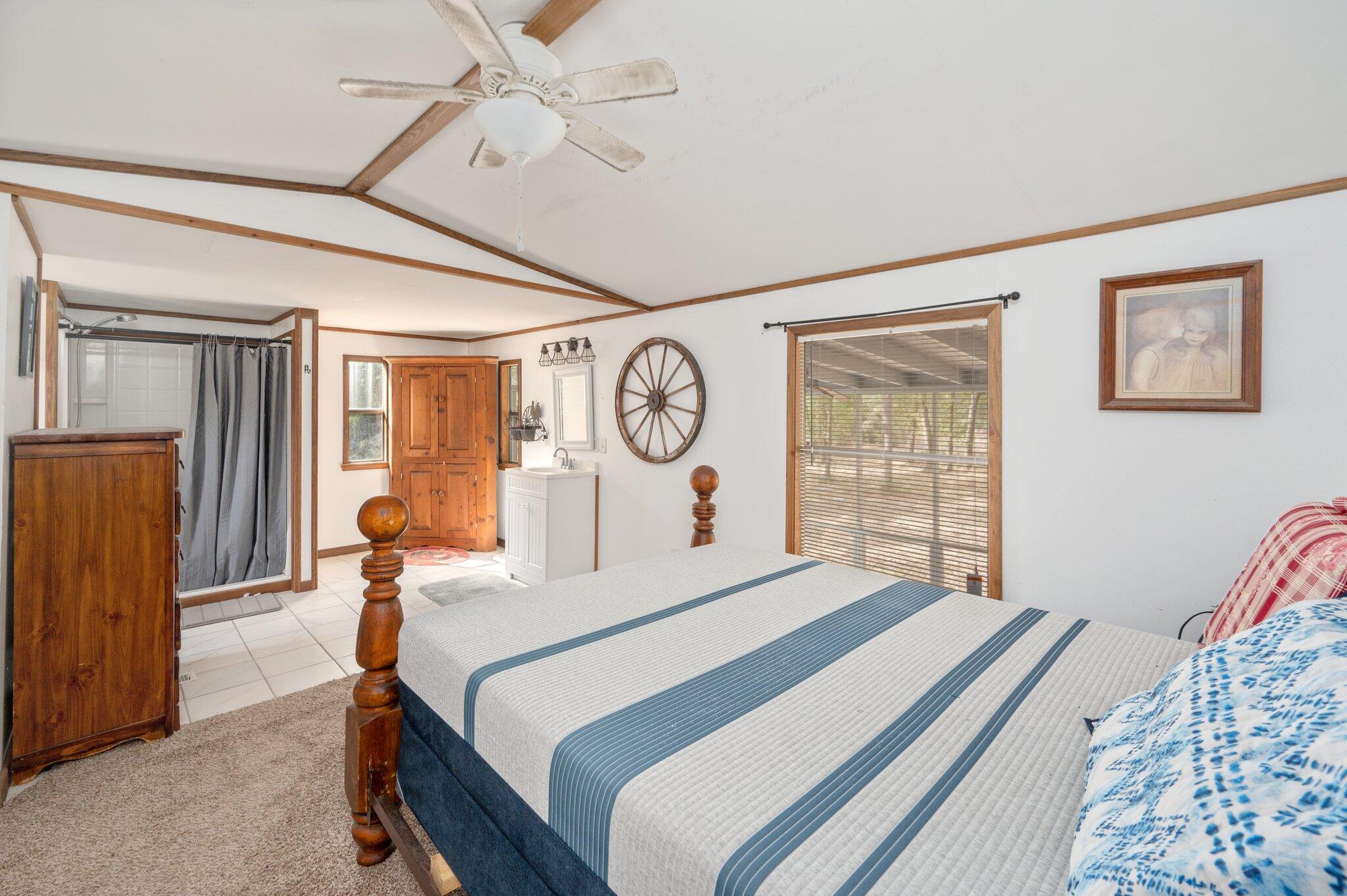 4507 Rainbird Rise Road Crestview, FL 32539 - Photo 14 of 33 a bedroom with a bed and a chandelier