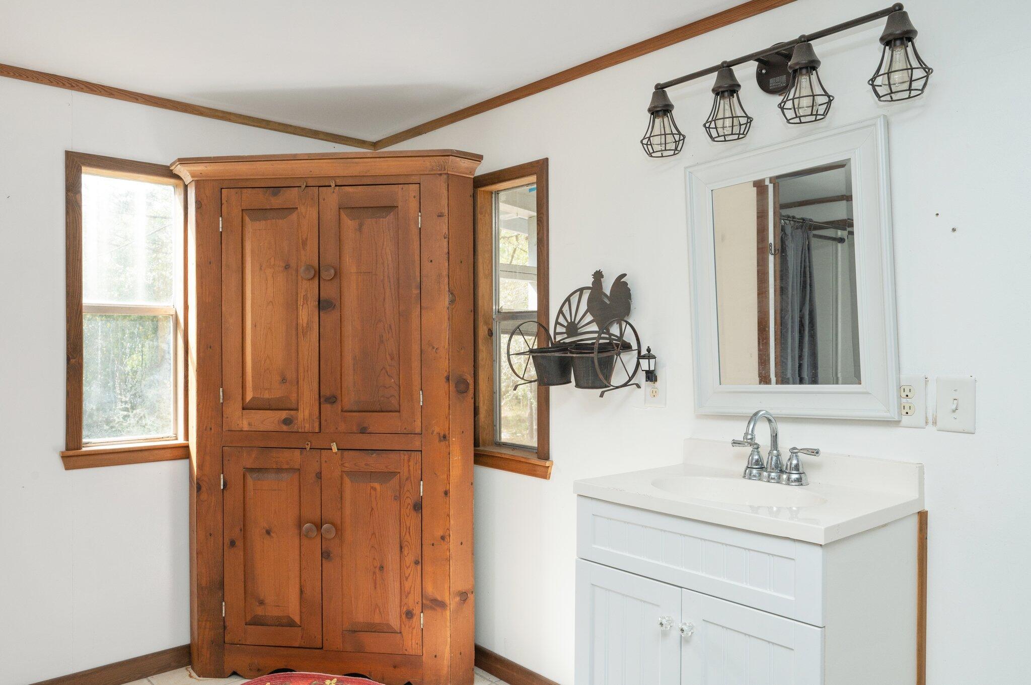4507 Rainbird Rise Road Crestview, FL 32539 - Photo 16 of 33 a bathroom with a sink and a mirror