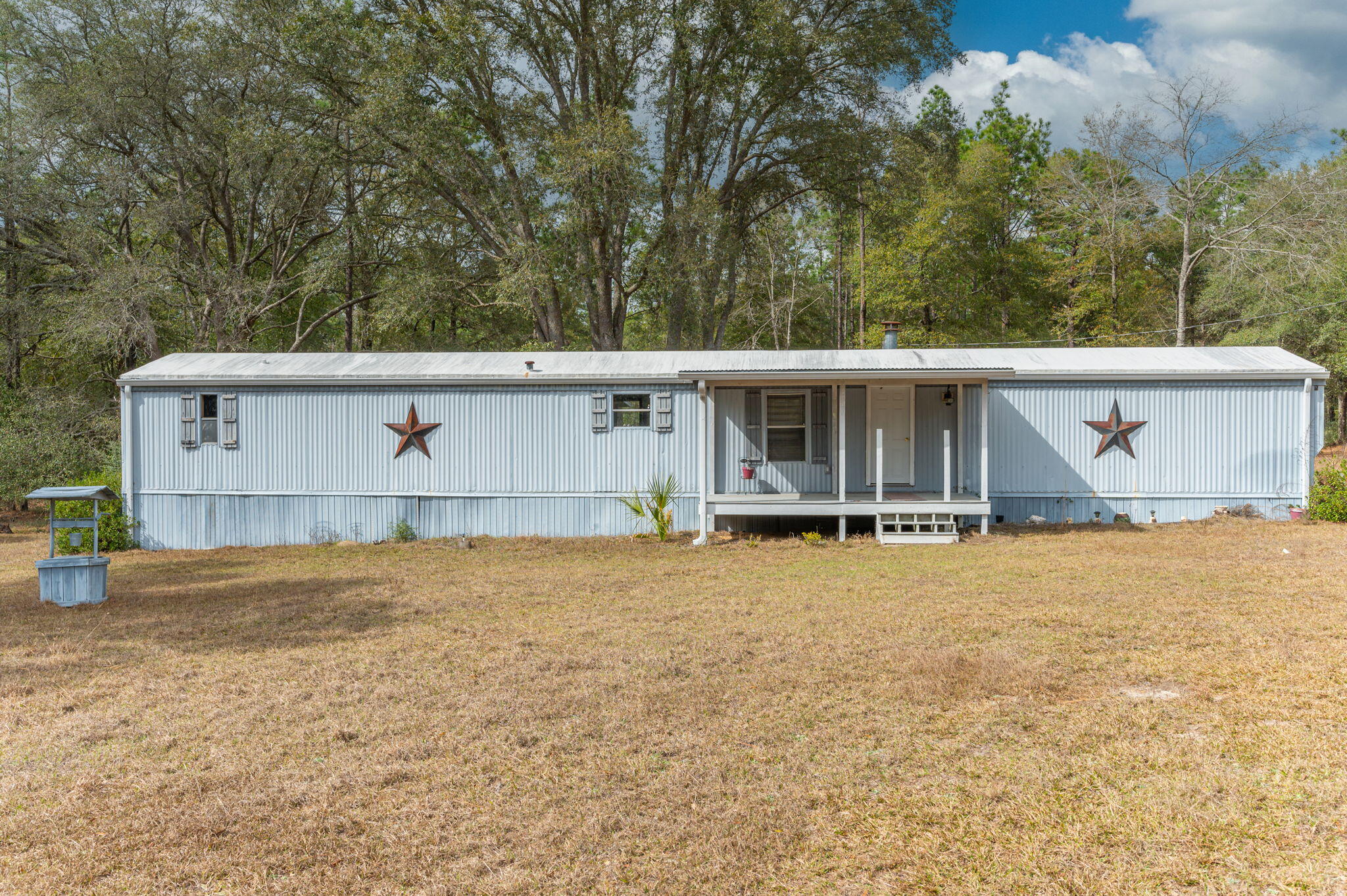 4507 Rainbird Rise Road Crestview, FL 32539 - Photo 2 of 33 a view of a house with a yard and large tree