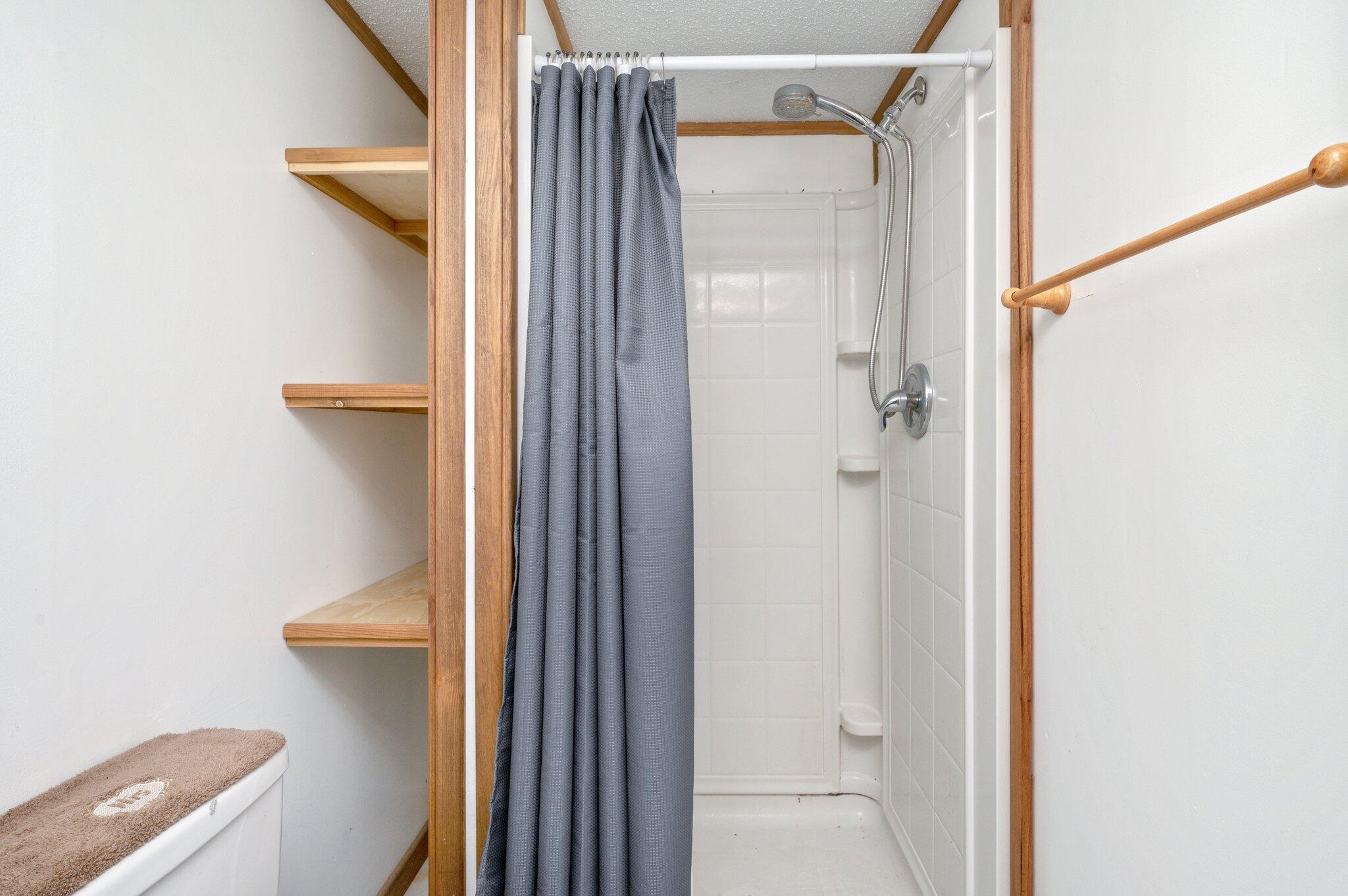 4507 Rainbird Rise Road Crestview, FL 32539 - Photo 22 of 33 a bathroom with a shower and a glass door