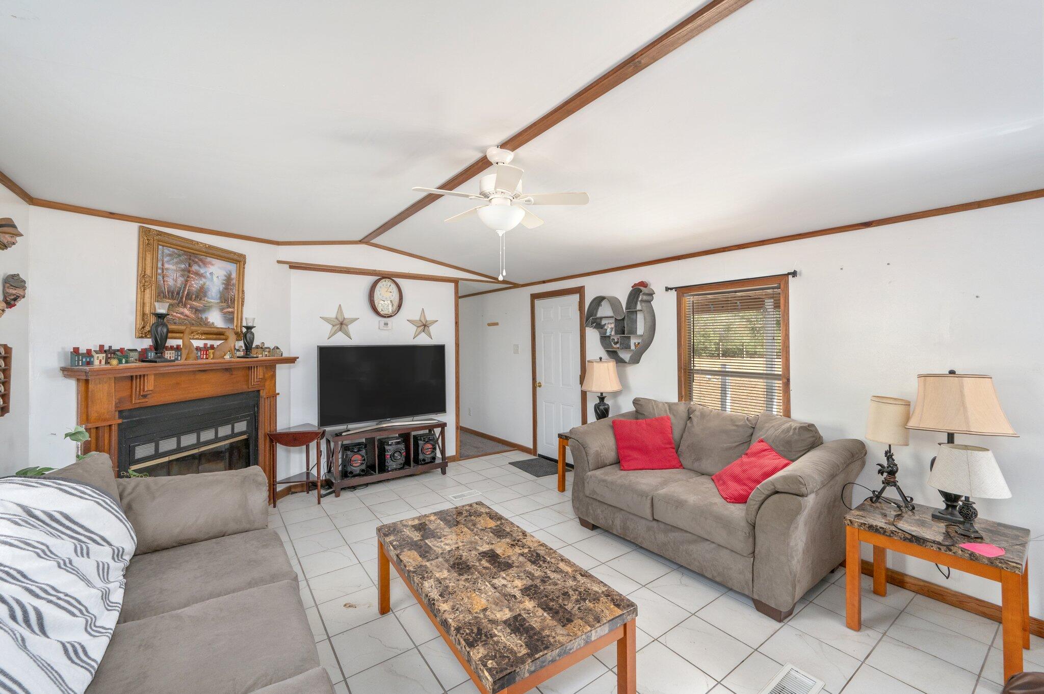 4507 Rainbird Rise Road Crestview, FL 32539 - Photo 9 of 33 a living room with furniture and a flat screen tv