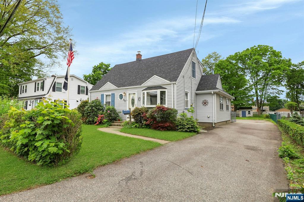 17 Butler Place Wanaque, NJ 07420 - Photo 2 of 28 a front view of a house with a yard and garage