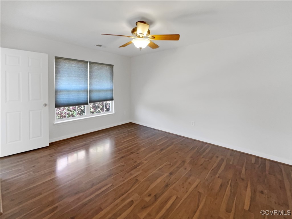 6385 Eagles Crest Lane Chesterfield, VA 23832 - Photo 13 of 24 a view of an empty room with wooden floor and a ceiling fan