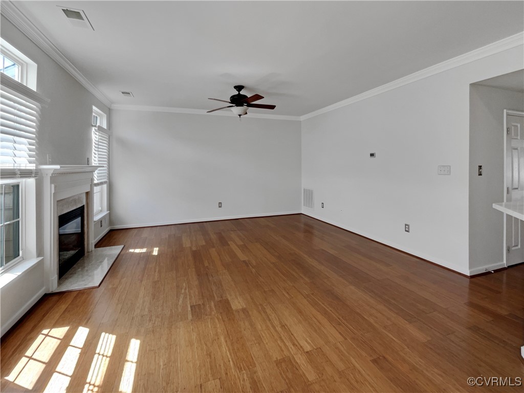 6385 Eagles Crest Lane Chesterfield, VA 23832 - Photo 9 of 24 an empty room with wooden floor fireplace and windows