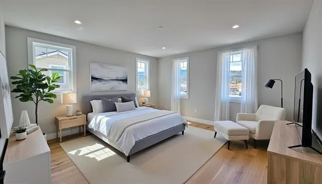 a bedroom with a bed and wooden floor