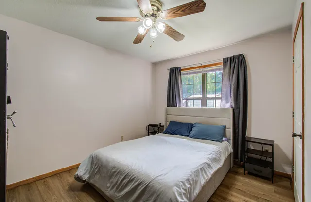 a bedroom with a bed and a window