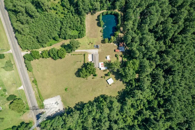 an aerial view of a house with a yard