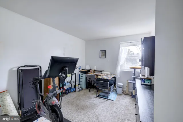 a view of a workspace with furniture and a window