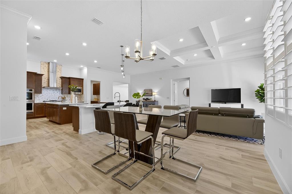 994 Signet Drive Apollo Beach, FL 33572 - Photo 29 of 98 a living room with furniture kitchen view and a chandelier