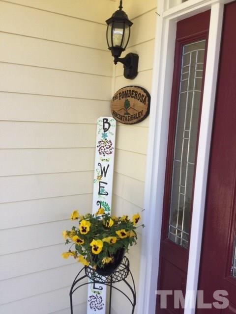 7908 Milltrace Run Raleigh, NC 27615 - Photo 4 of 20 a table with a vase and flowers on it