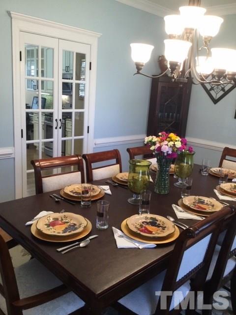 7908 Milltrace Run Raleigh, NC 27615 - Photo 8 of 20 a view of a dining room with furniture and chandelier