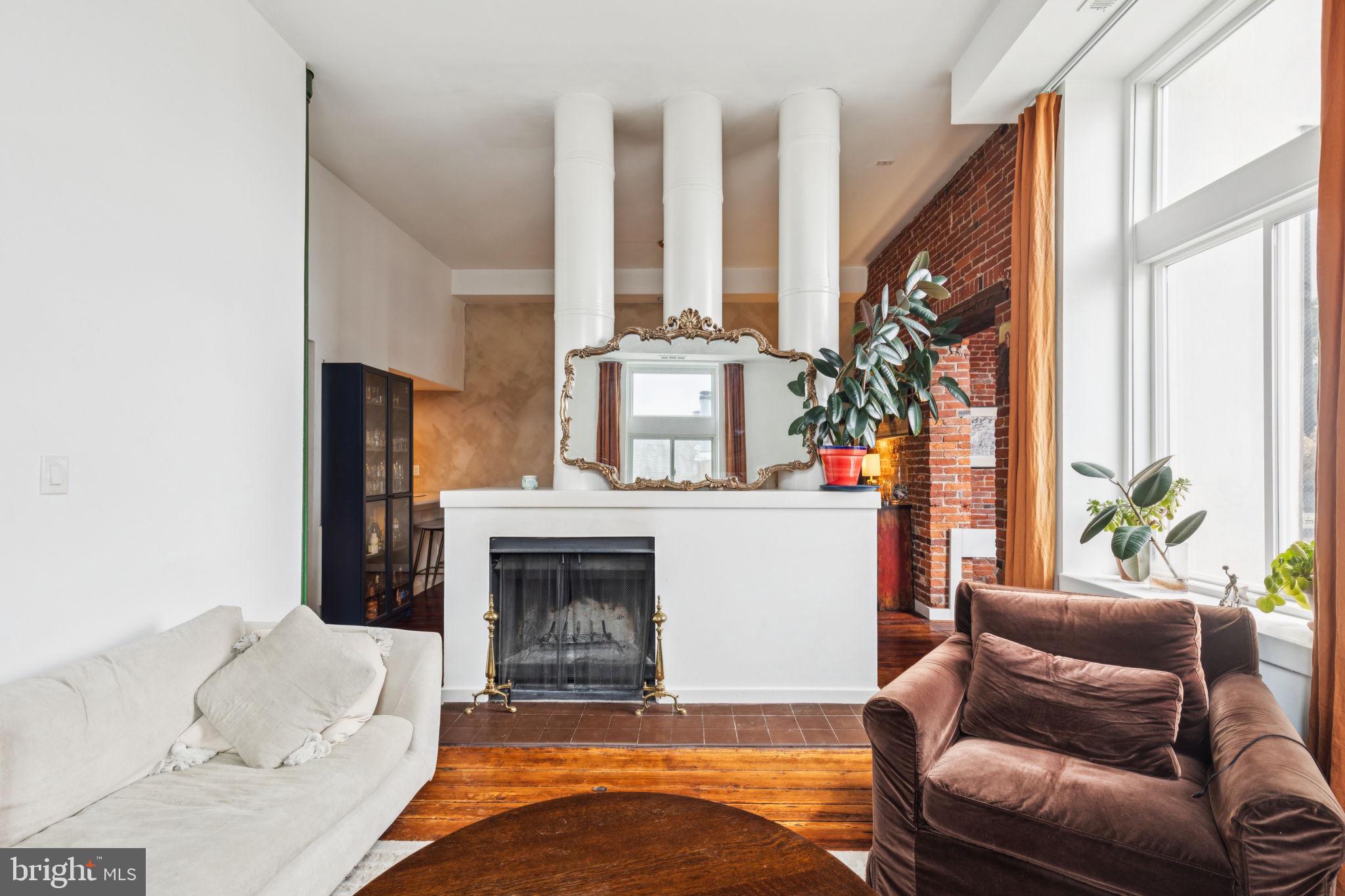 765 South 2nd Street, Unit G Philadelphia, PA 19147 - Photo 1 of 31 a living room with furniture a fireplace and a large window
