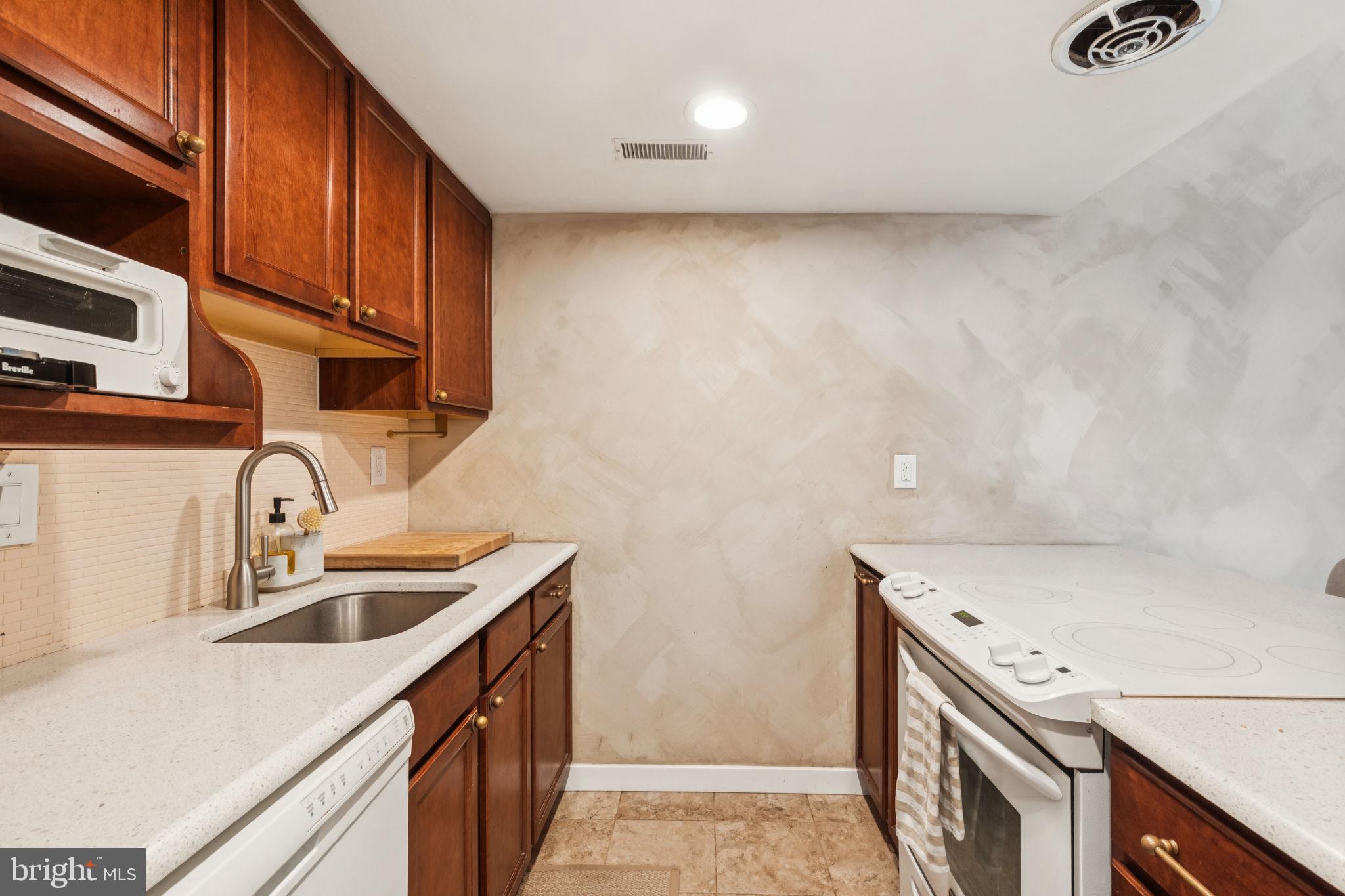 765 South 2nd Street, Unit G Philadelphia, PA 19147 - Photo 16 of 31 a kitchen with a sink a stove and cabinets