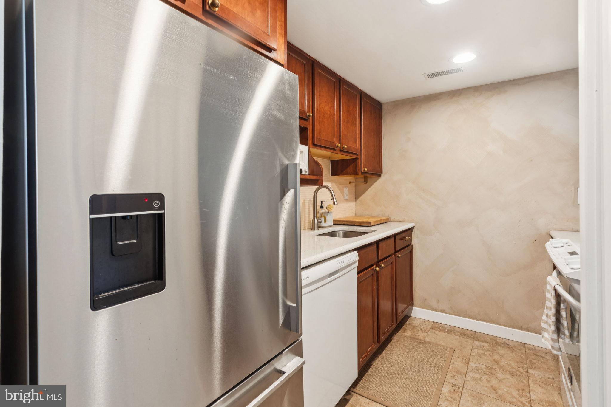 765 South 2nd Street, Unit G Philadelphia, PA 19147 - Photo 17 of 31 a kitchen with stainless steel appliances granite countertop a refrigerator and a sink