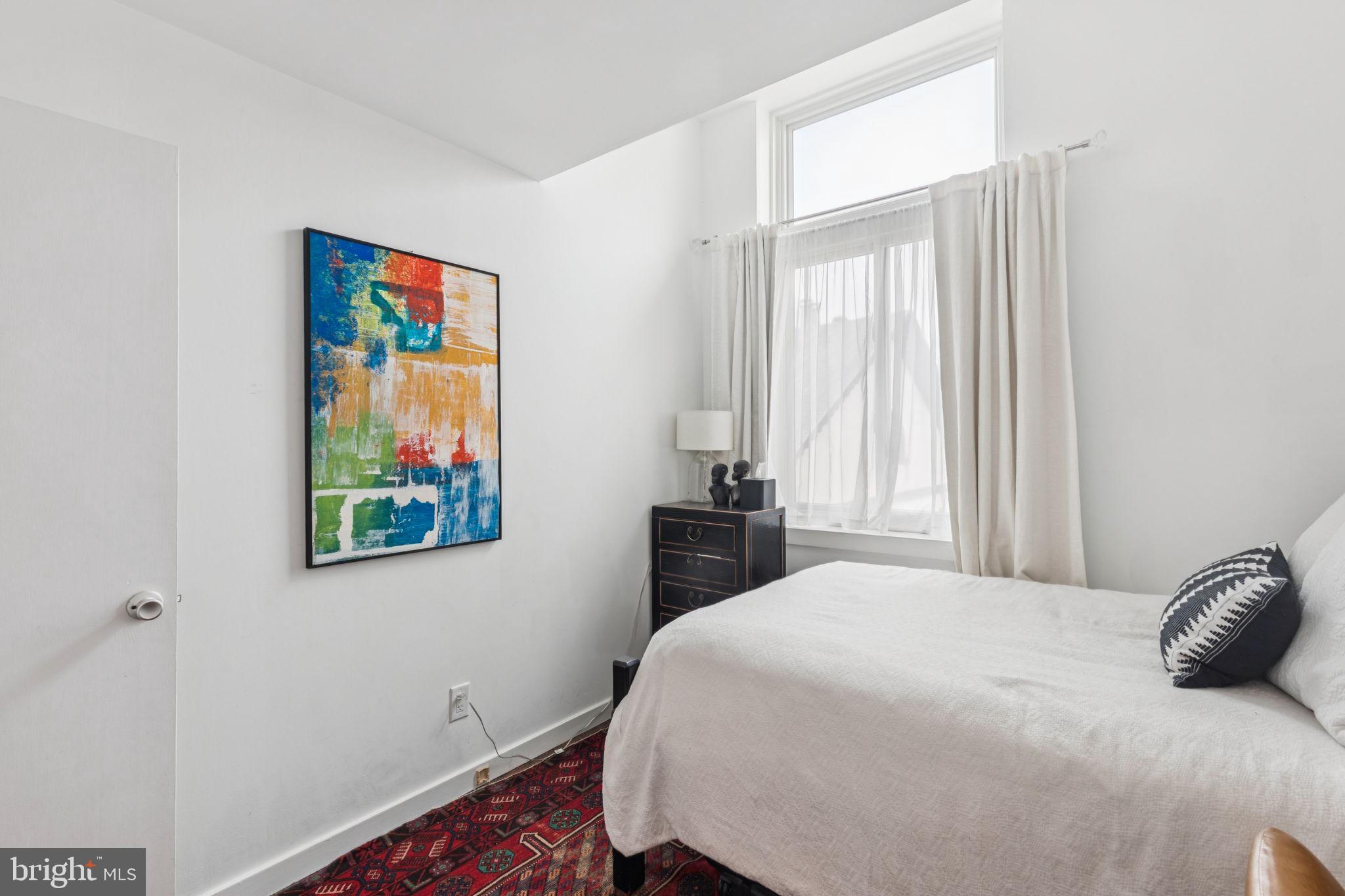 765 South 2nd Street, Unit G Philadelphia, PA 19147 - Photo 27 of 31 a bedroom with a bed and a window