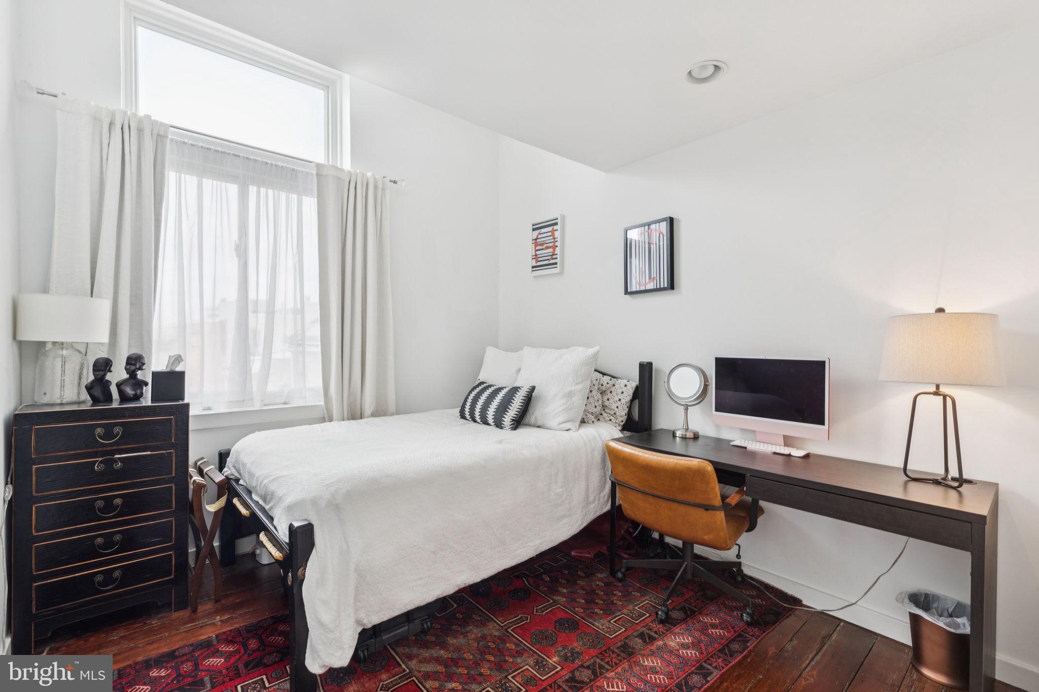 765 South 2nd Street, Unit G Philadelphia, PA 19147 - Photo 28 of 31 a bedroom with a bed and a flat screen tv