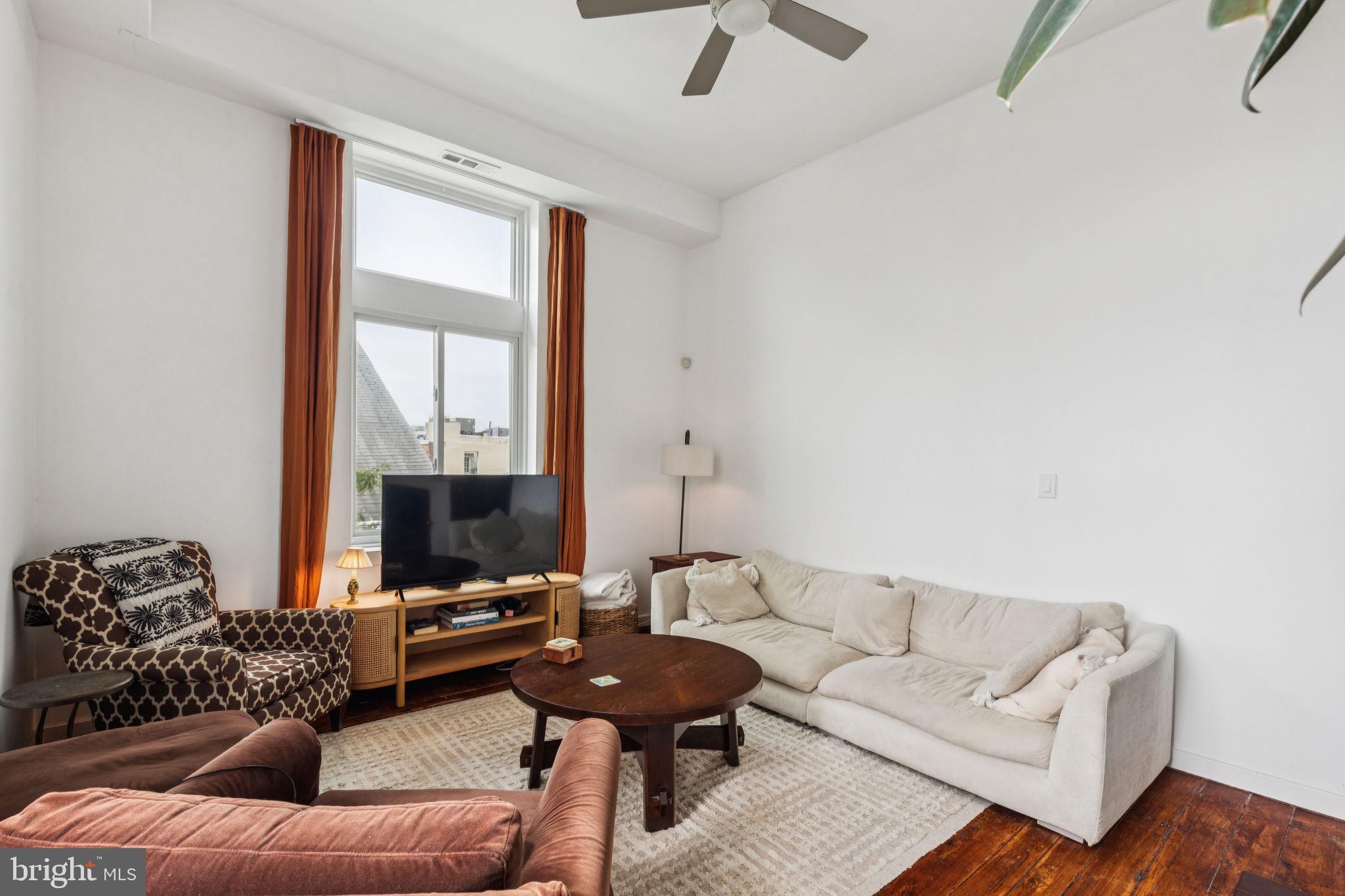 765 South 2nd Street, Unit G Philadelphia, PA 19147 - Photo 7 of 31 a living room with furniture and a large window