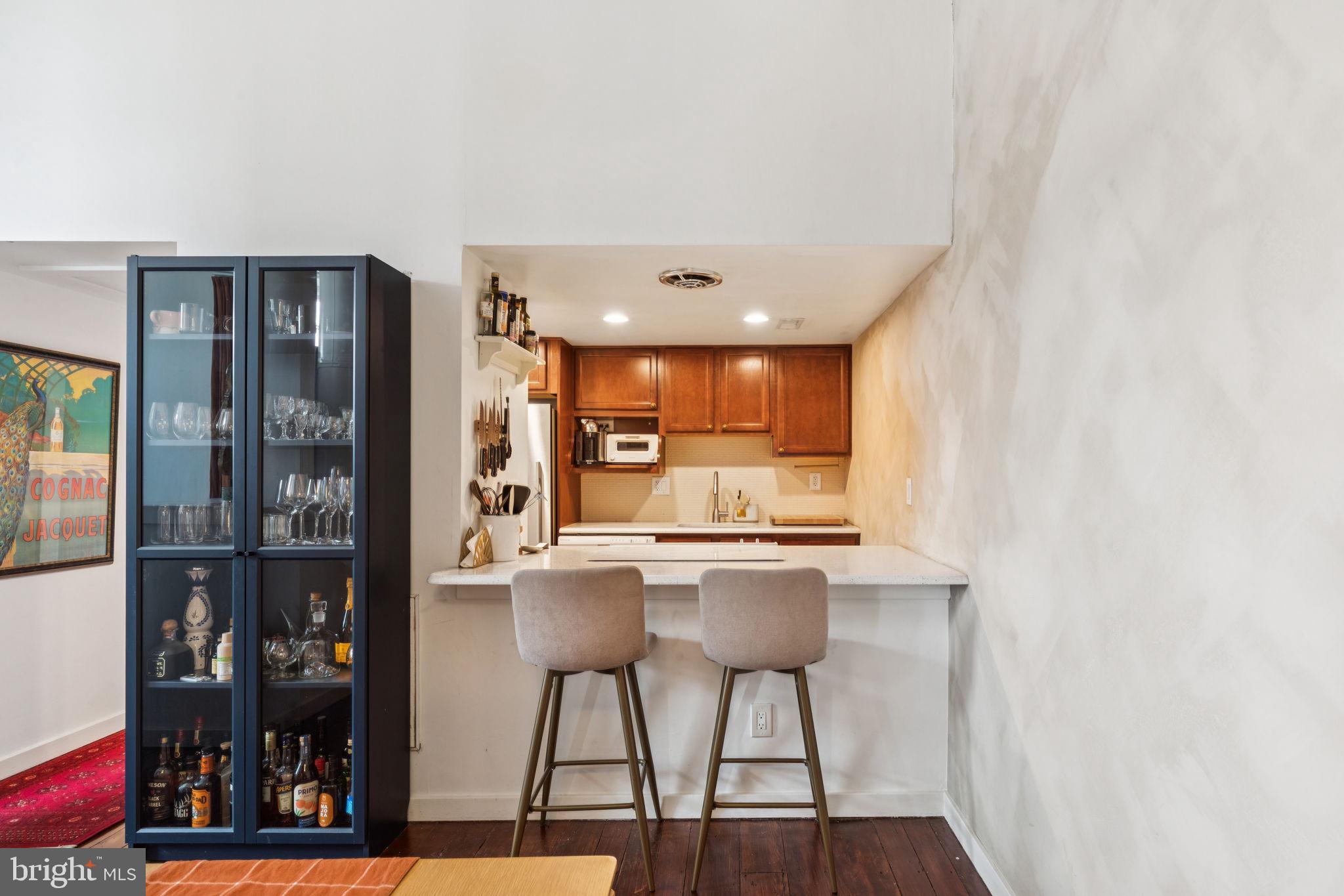 765 South 2nd Street, Unit G Philadelphia, PA 19147 - Photo 9 of 31 a kitchen with stainless steel appliances a dining table chairs and a refrigerator