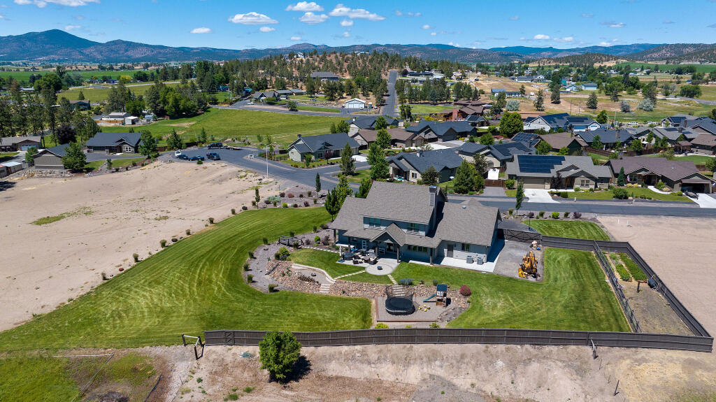 344 Northwest Saddle Ridge Loop Prineville, OR 97754 - Photo 17 of 64 an aerial view of a house with a garden and lake view