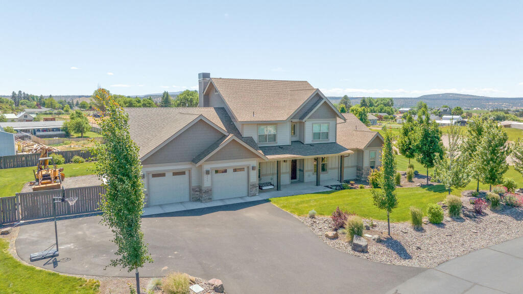 344 Northwest Saddle Ridge Loop Prineville, OR 97754 - Photo 2 of 64 an aerial view of a house with swimming pool garden and lake view