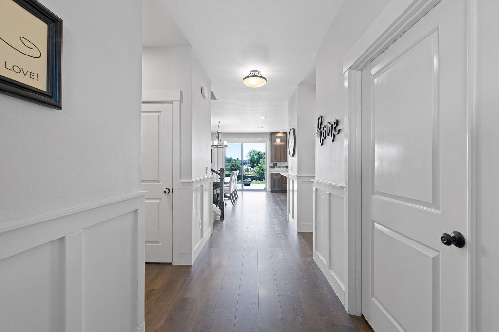 344 Northwest Saddle Ridge Loop Prineville, OR 97754 - Photo 26 of 64 a view of a hallway with wooden floor windows and a livingroom