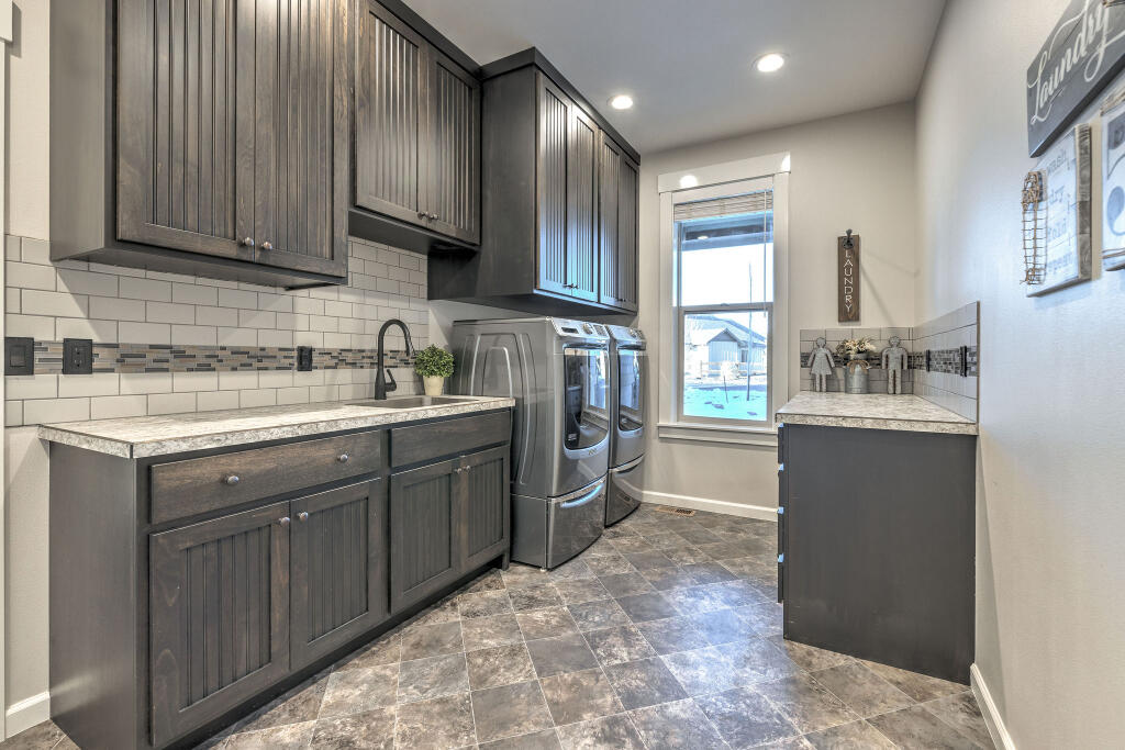 344 Northwest Saddle Ridge Loop Prineville, OR 97754 - Photo 50 of 64 a kitchen with a sink stove and cabinets
