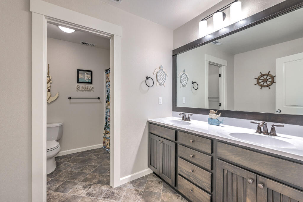 344 Northwest Saddle Ridge Loop Prineville, OR 97754 - Photo 57 of 64 a bathroom with a sink a toilet and a mirror