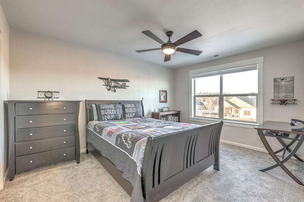 344 Northwest Saddle Ridge Loop Prineville, OR 97754 - Photo 60 of 64 a bed room with a bed and a chair