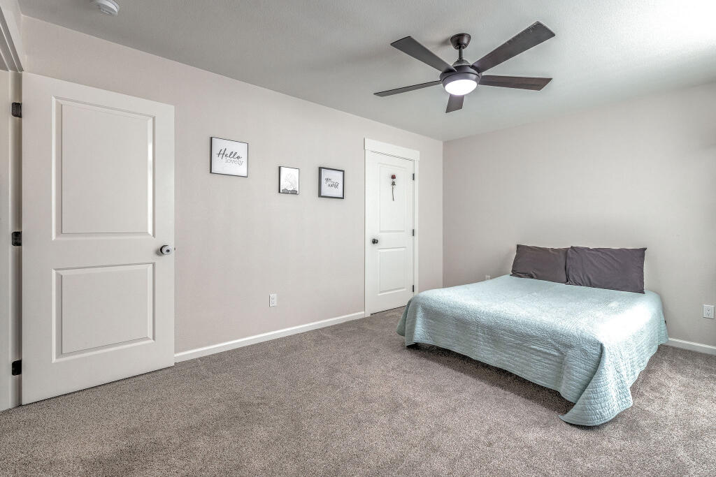 344 Northwest Saddle Ridge Loop Prineville, OR 97754 - Photo 62 of 64 a bedroom with a bed and a ceiling fan