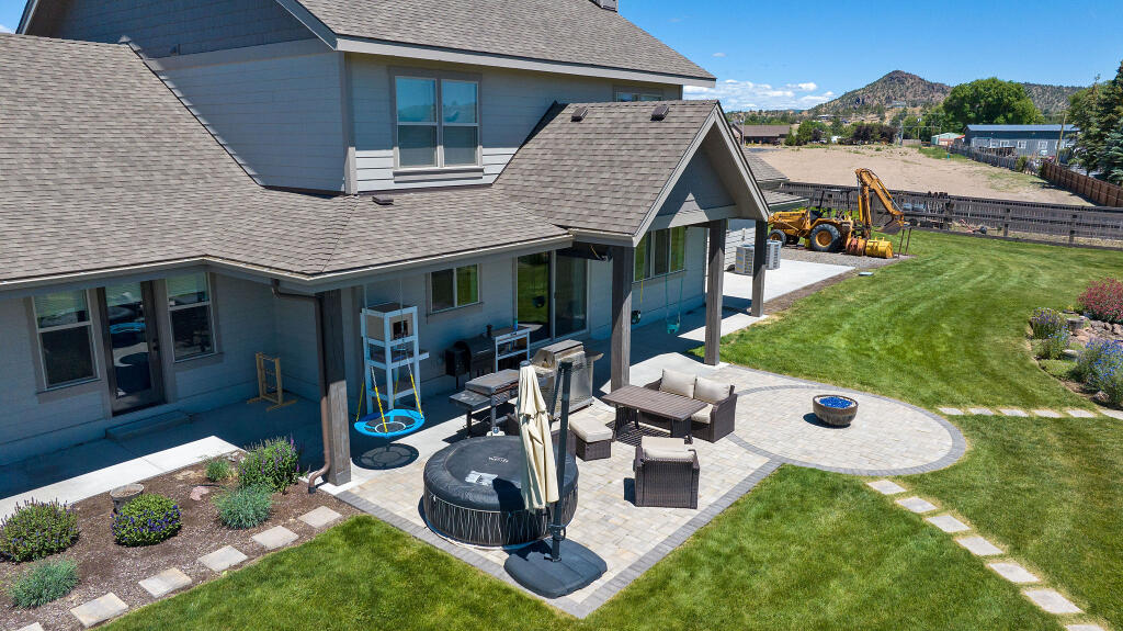 344 Northwest Saddle Ridge Loop Prineville, OR 97754 - Photo 7 of 64 a view of a house with backyard tub and sitting area