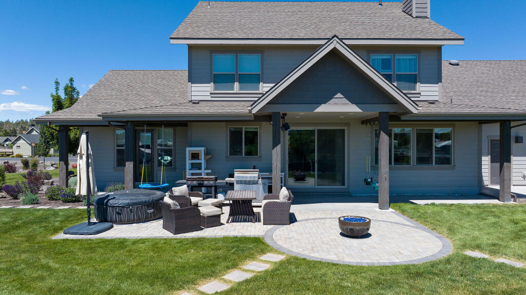 344 Northwest Saddle Ridge Loop Prineville, OR 97754 - Photo 9 of 64 a view of a house with backyard porch and sitting area