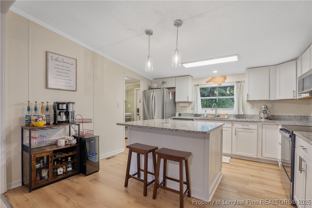 54 West Tryon Court Spring Lake, NC 28390 - Photo 12 of 43 a kitchen with sink cabinets and window