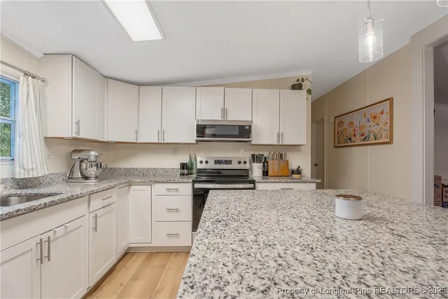 a kitchen with a sink stove and cabinets