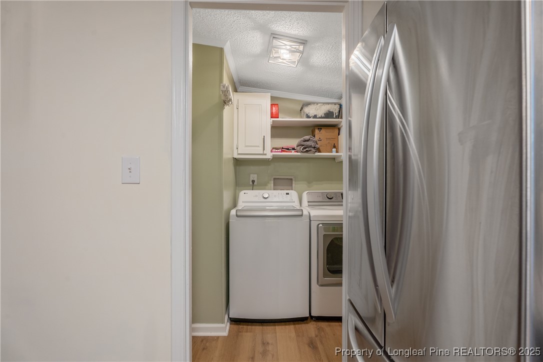 54 West Tryon Court Spring Lake, NC 28390 - Photo 16 of 43 a utility room with wooden floor washer and dryer