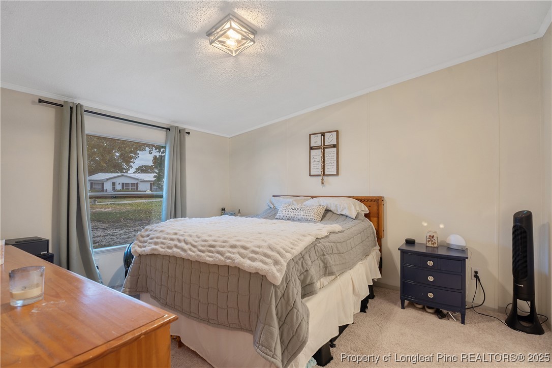 54 West Tryon Court Spring Lake, NC 28390 - Photo 18 of 43 a bedroom with bed and window