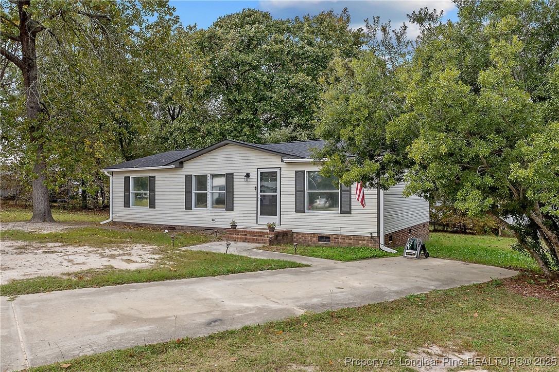 54 West Tryon Court Spring Lake, NC 28390 - Photo 2 of 43 a front view of a house with a yard and garage