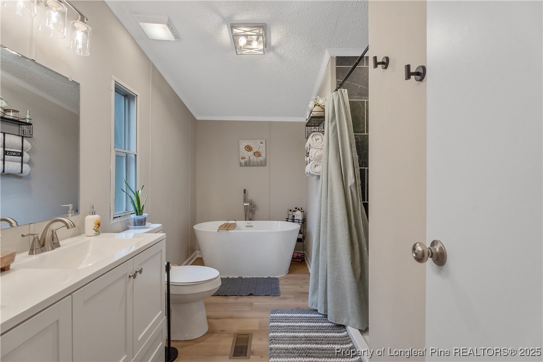 54 West Tryon Court Spring Lake, NC 28390 - Photo 22 of 43 a bathroom with a toilet sink and mirror