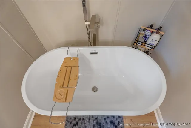 a bathroom with a tub and mirror
